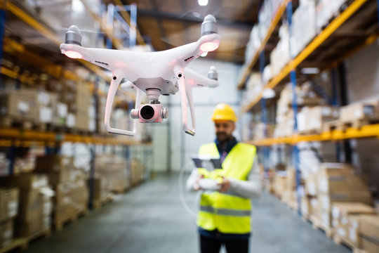 Man with drone in a warehouse.