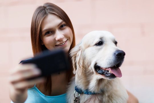 Photo of brunette doing selfie with dog