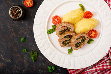 Roll of turkey minced meat with spinach and red sweet pepper with garnish of mashed potatoes