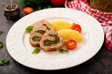 Roll of turkey minced meat with spinach and red sweet pepper with garnish of mashed potatoes