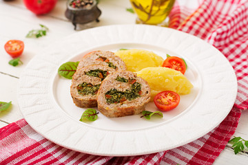 Roll of turkey minced meat with spinach and red sweet pepper with garnish of mashed potatoes