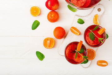 Sangria with fruits and mint on a white background. Top view