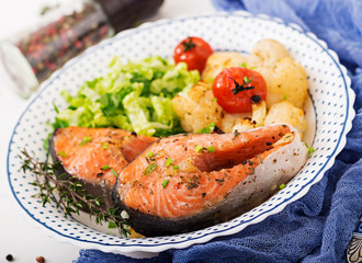 Dietary menu. Baked salmon steak with cauliflower, tomatoes and herbs. Proper nutrition. Healthy lifestyle