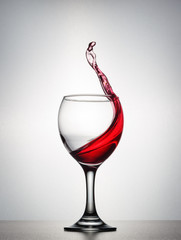 A splash of red wine in the wine glass.