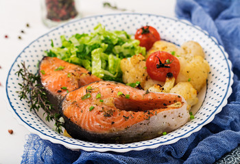 Dietary menu. Baked salmon steak with cauliflower, tomatoes and herbs. Proper nutrition. Healthy lifestyle