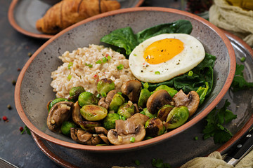 Healthy breakfast. Oat porridge, egg and salad of baked vegetables - mushrooms and Brussels sprouts. Healthy lifestyle.
