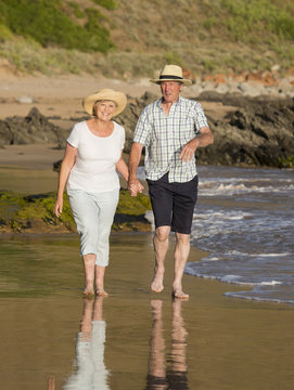 lovely senior mature couple on their 60s or 70s retired walking