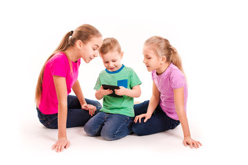 Group of little kids looking into tablet pc