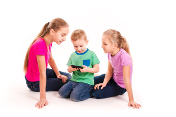 Fototapeta na wymiar Group of little kids looking into tablet pc