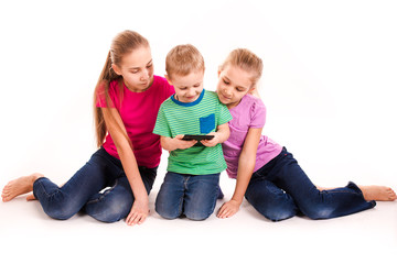 Group of little kids looking into tablet pc