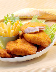 Breaded Fried fish with potato fries and tomato ketchup with lemon cherry tomato