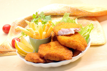 Breaded Fried fish with potato fries and tomato ketchup with lemon cherry tomato
