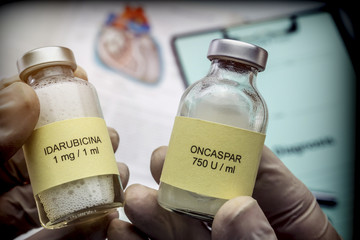 Doctor holds two vials of idarubicina and Oncaspar to inject, medicine used in acute lymphatic...