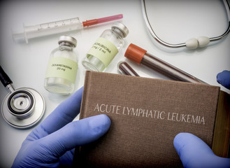 Doctor holds in its hands a book on the Acute lymphatic leukemia, conceptual image