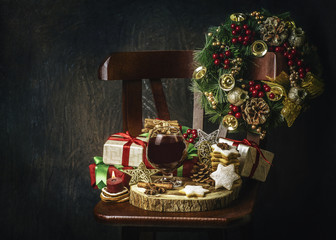 Classic still life with Christmas drink served with freshly baked and Christmas decorations on vintage chair.Holidays and Events Drink.