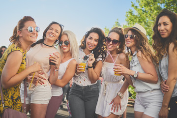 Small group of girlfriends posing at outdoor pary - obrazy, fototapety, plakaty