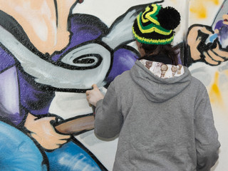 Male Street Artist: Spraying on Public Urban City Wall
