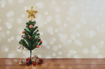 Fototapeta na wymiar Christmas tree decoration with circle Bokeh lights on wooden floor, in living room