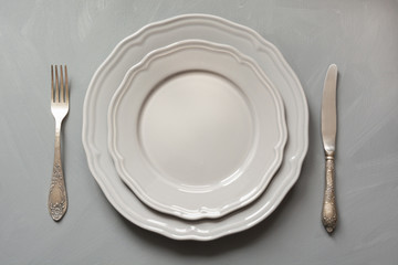 Table place setting on gray. Top view. Concept.