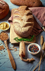 Bread and pastries in a composition with kitchen accessories on an old background