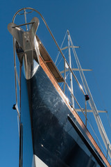 Bow of a sailing yacht on blue sky background