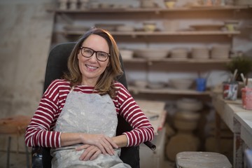 Female potter relaxing on chair