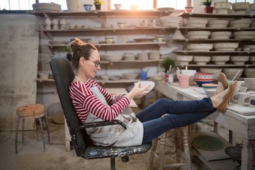 Woman sitting on chair checking bowl