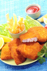 Breaded Fried fish with potato fries and tomato ketchup with lemon cherry tomato