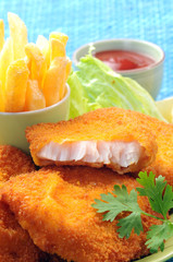 Breaded Fried fish with potato fries and tomato ketchup with lemon cherry tomato