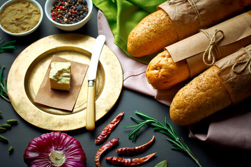 Bread and pastries in a composition with kitchen accessories on an old background