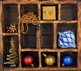 Composition on vintage wooden box with colored christmas toys