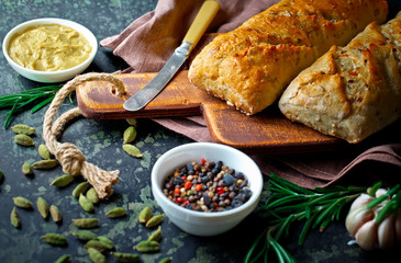 Bread and pastries in a composition with kitchen accessories on an old background