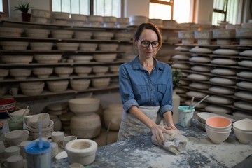 Female potter molding a clay