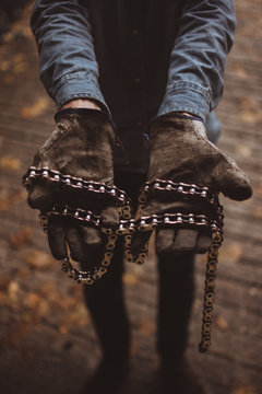 Man holding motorcycle chains