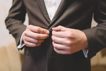 groom hands dressing