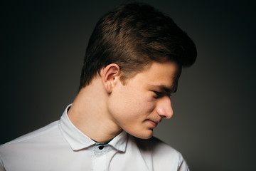 young brunette guy in a white shirt