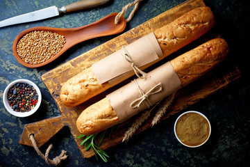 Bread and pastries in a composition with kitchen accessories on an old background