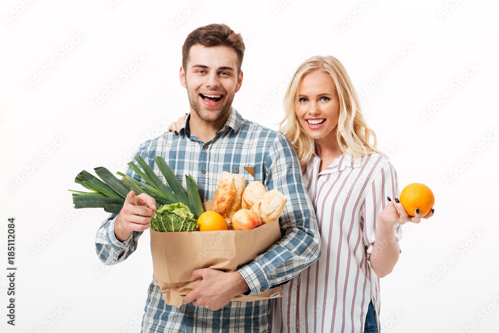 Sticker Portrait of an attractive couple holding paper shopping bag