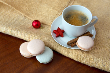 Colorful macaroons and coffee cup. Christmas card.