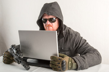 An evil hacker with a gun, red hair, a beard and a mustache. Penetration into the home, hacking...