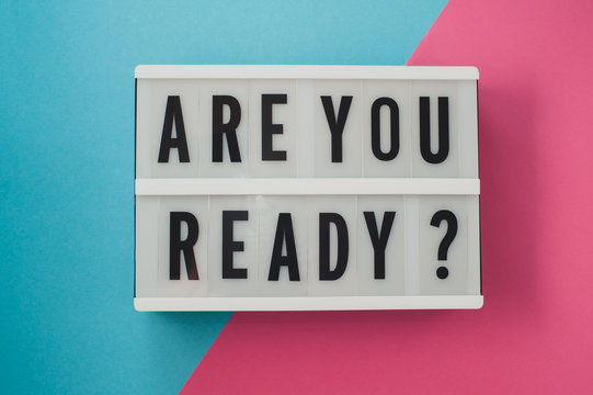 Are you ready - text on a display on blue and pink bright background.