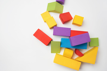 Multi-colored toy building blocks on a white background