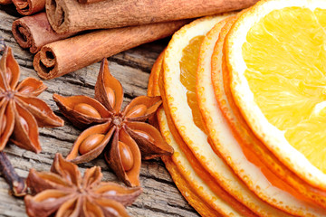 Dried orange with cinnamon sticks and star anise on table