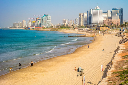 Tel Aviv beach coast with a view of Mediterranean sea and skyscrapers.