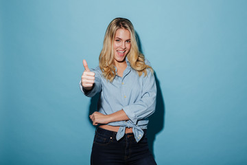 Happy blonde woman in shirt showing thumb up