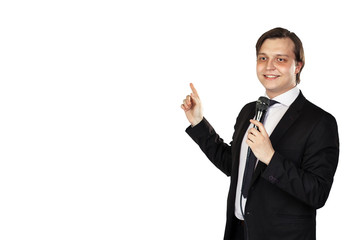 Young elegant talking man holding microphone talking with pointing finger.