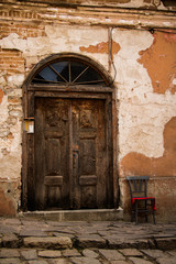 Fototapeta na wymiar Аn old wooden door to an abandoned house