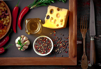 Raw pasta in the composition on the table with items for cooking