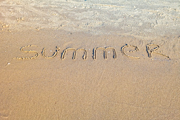 Fototapeta premium Word Summer written in the sand on the beach.