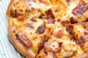 Close up of pizzas with variety of toppings and cheese in cardboard take out boxes with open lid